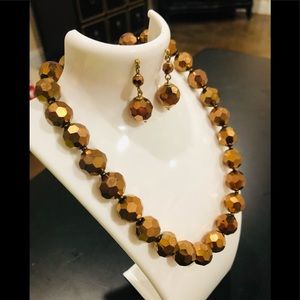 Matching brown metallic necklace and earrings with gold chain/clasp.